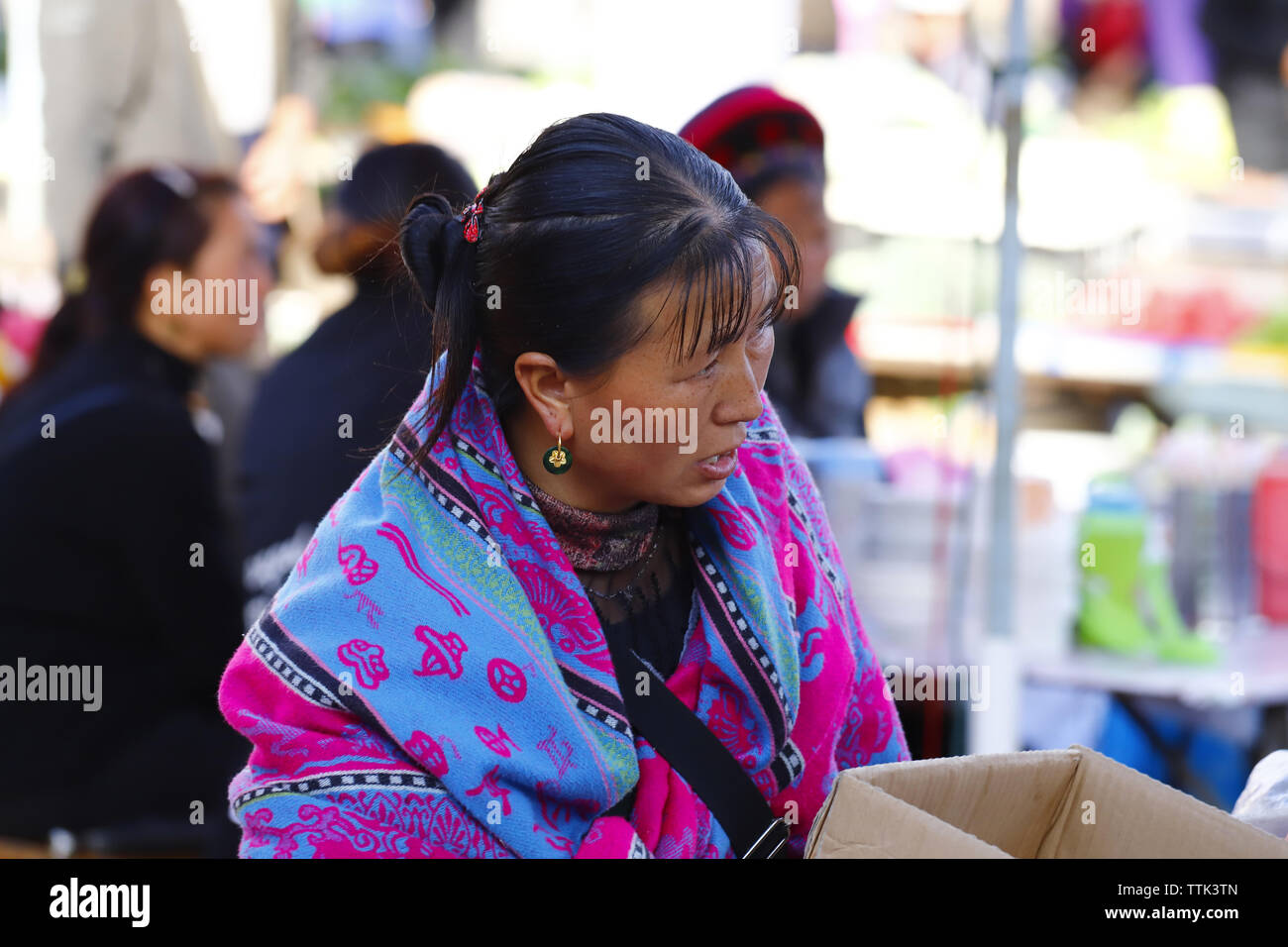 People of an ethnic minority of Yunnan with their traditional clothes in the market of Zhoucheng village, Dali, Yunnan, China Stock Photo