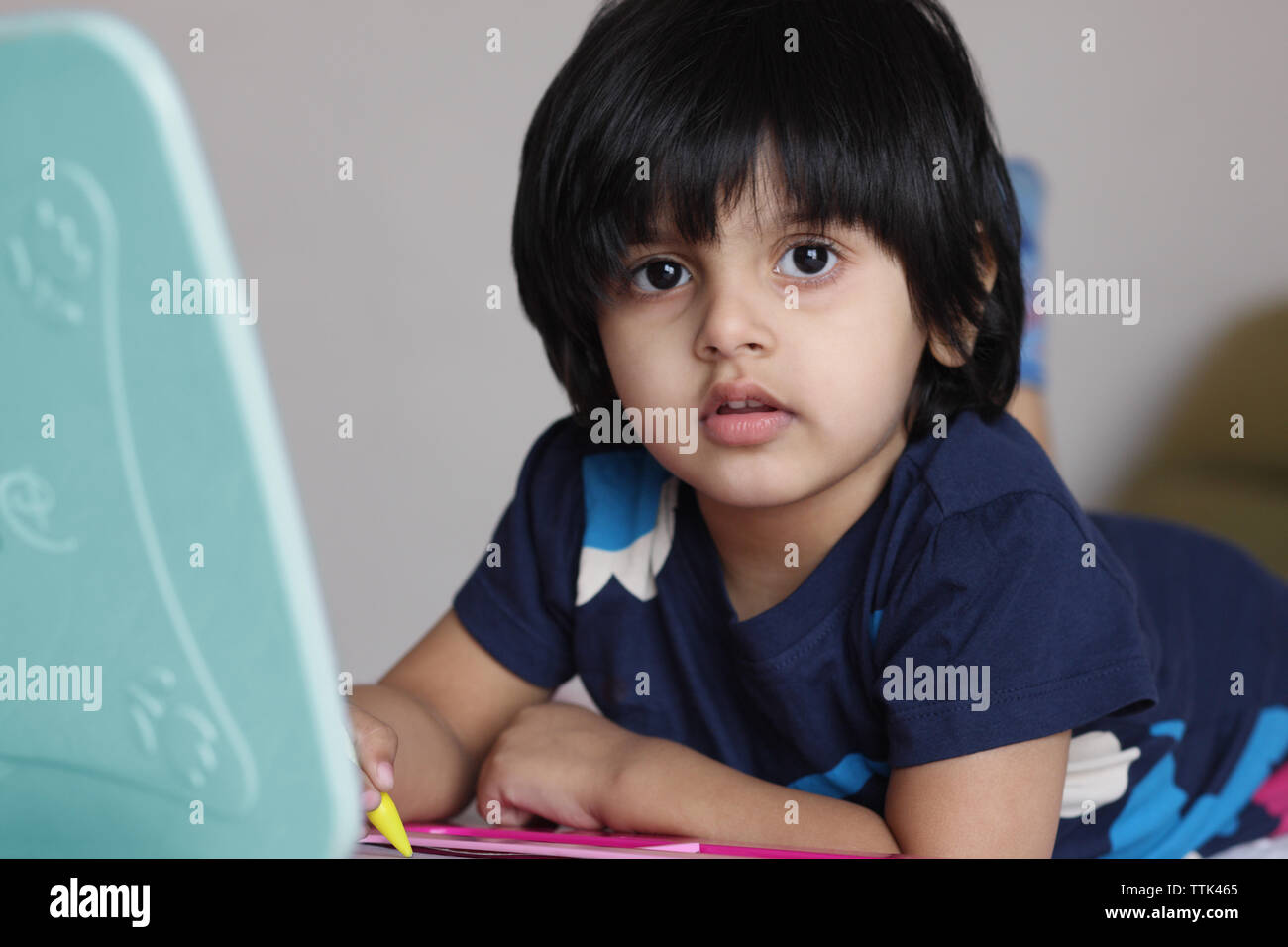 Indian girl using a magna doodle Stock Photo - Alamy