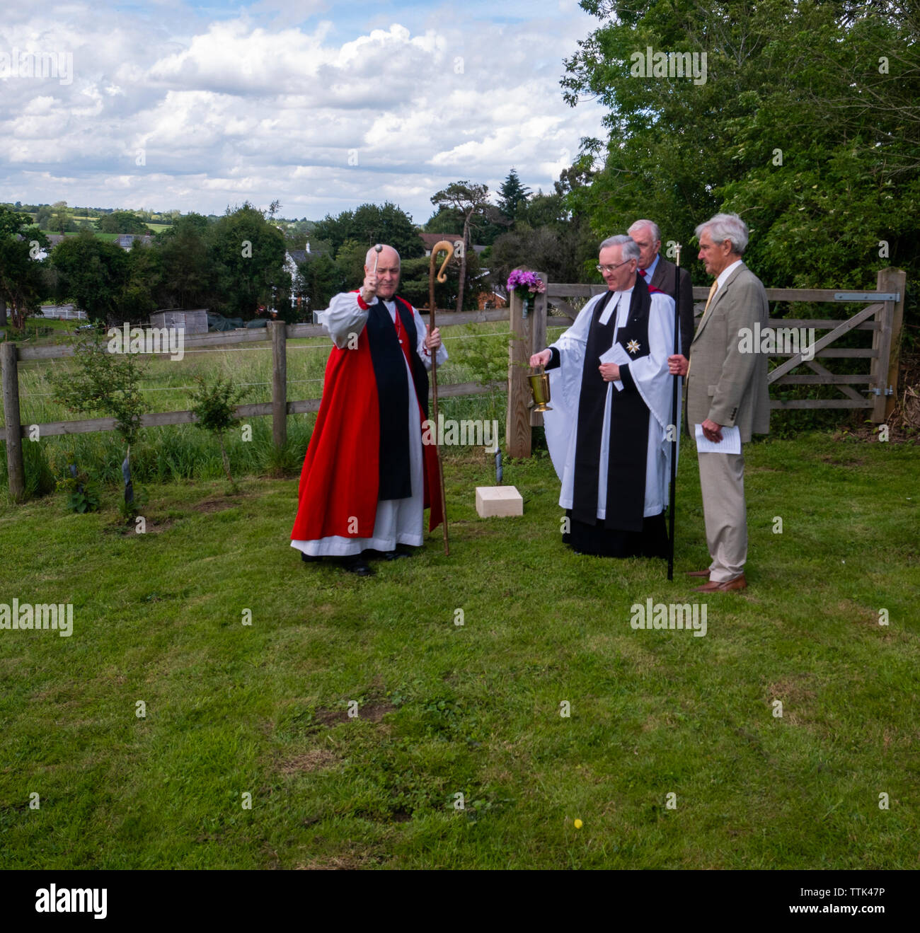 This service is very rarely performed as few churchyard extensions are being built.  The Bishop accompanied by the vicar the Reverend Doctor Robert Beaken and two church wardens walks around the plot making the sign of the cross with his staff and blessing the ground at each corner Stock Photo