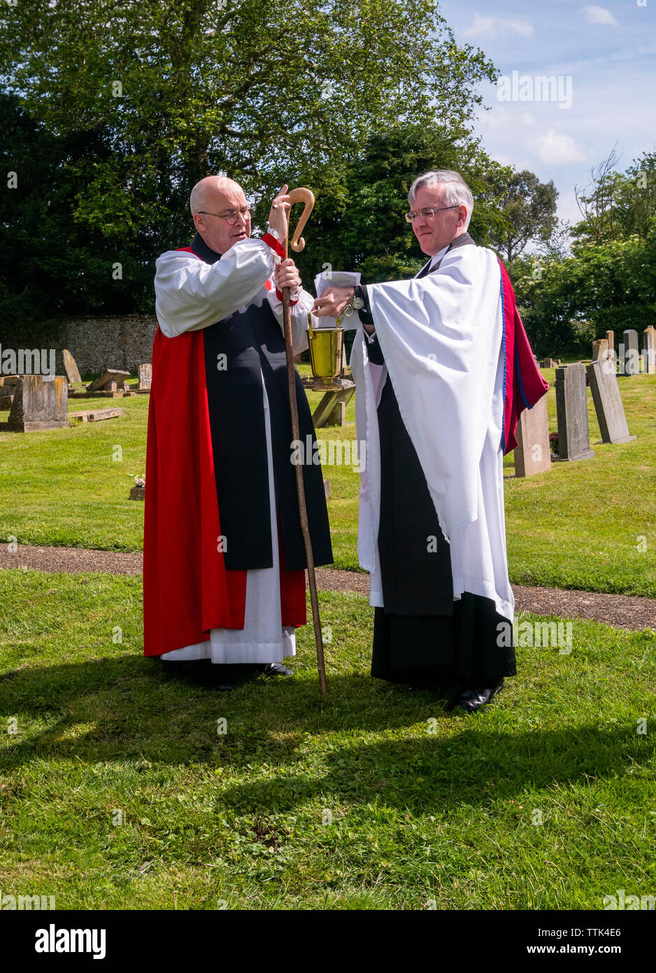 This service is very rarely performed as few churchyard extensions are being built.  The Bishop accompanied by the vicar the Reverend Doctor Robert Beaken and two church wardens walks around the plot making the sign of the cross with his staff and blessing the ground at each corner Stock Photo