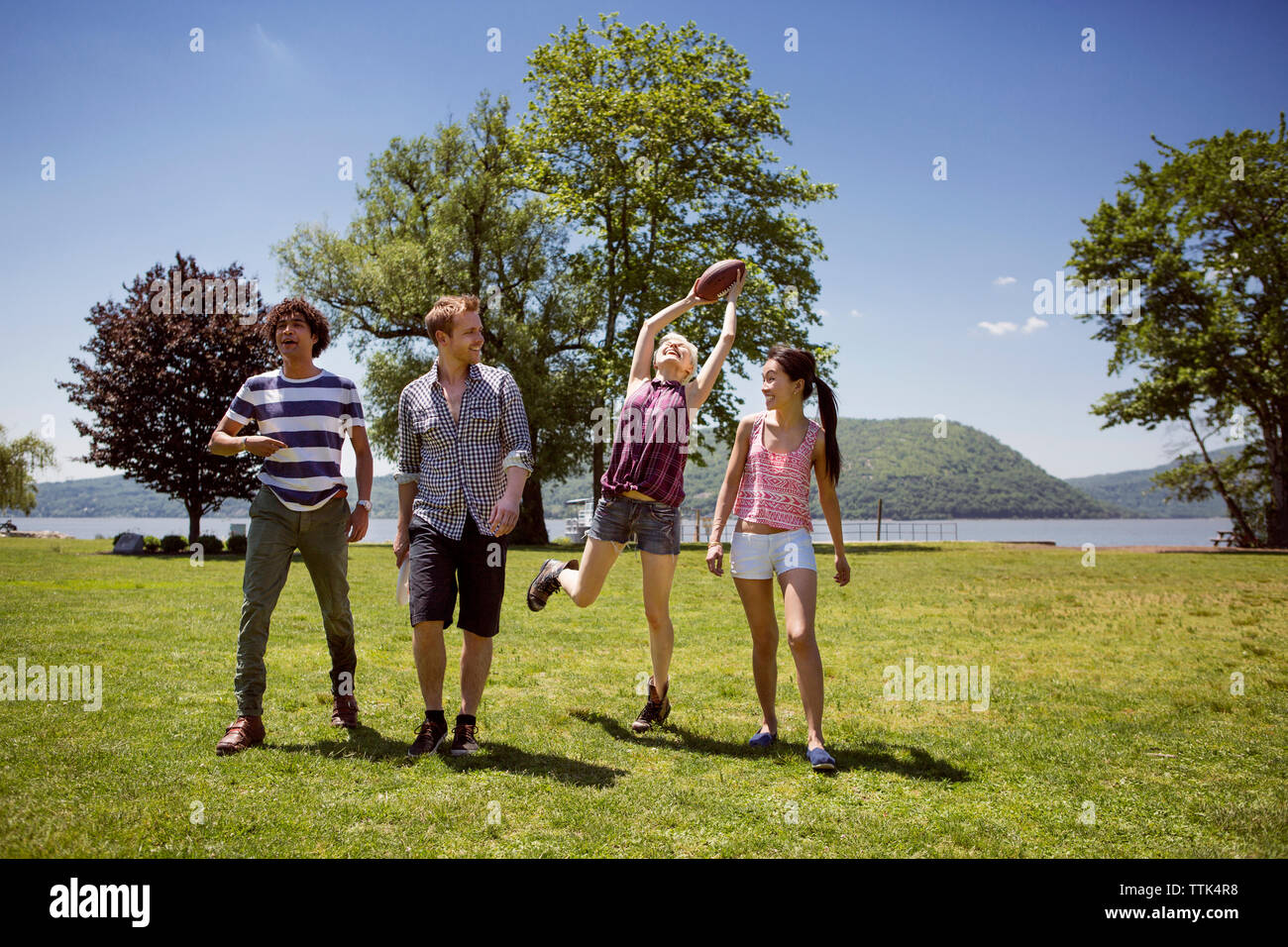 Friends enjoying at park against sky Stock Photo