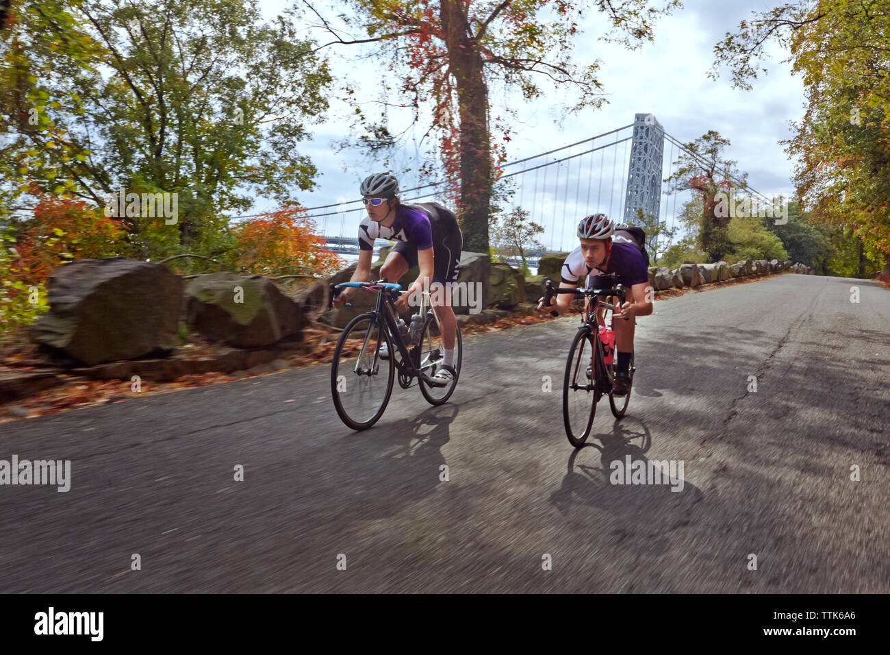 Cyclists racing on bicycle by George Washington Bridge Stock Photo