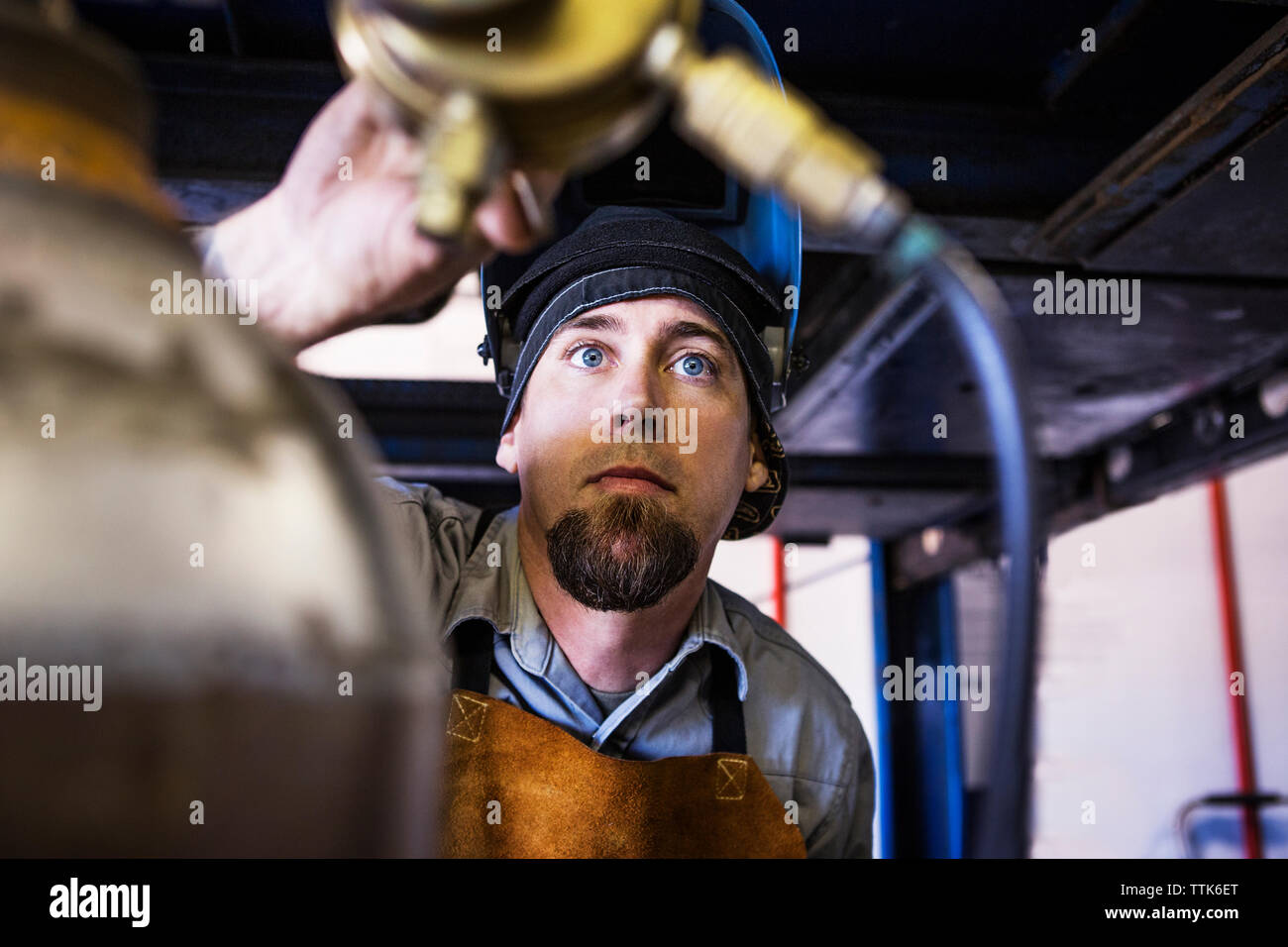 Mechanic adjusting pressure gauge at auto repair shop Stock Photo Alamy