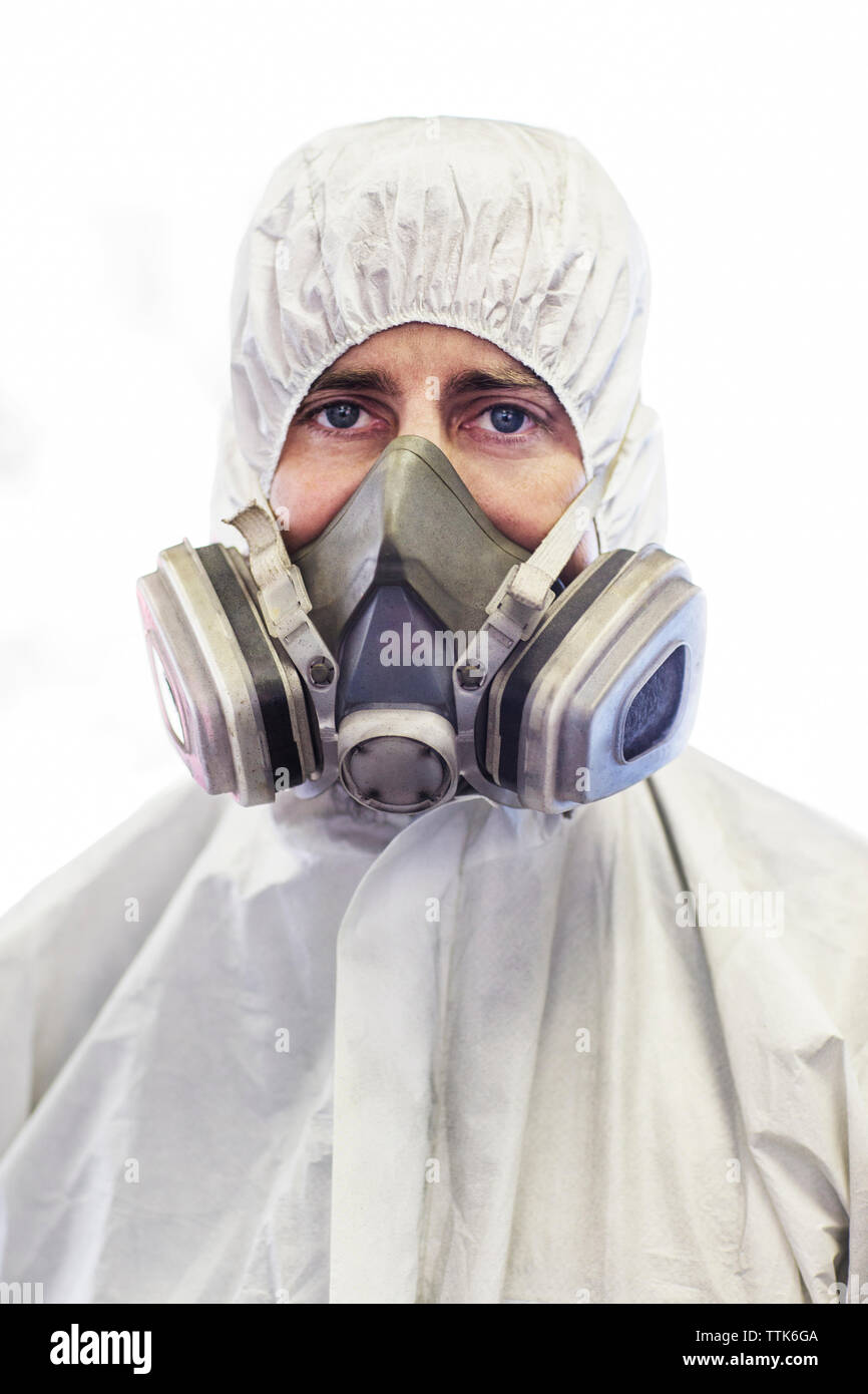 Portrait of mechanic with protective mask in auto body shop Stock Photo