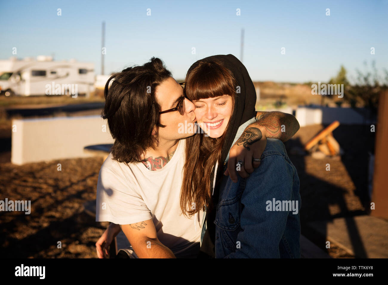 Couple walking while holding hands on field Stock Photo - Alamy