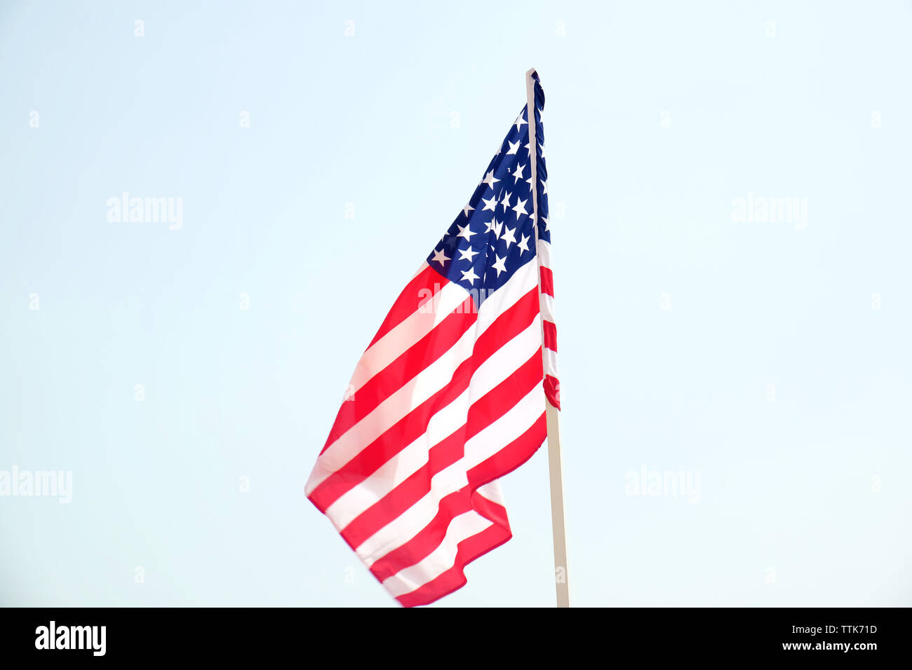 American flag on blue sky background Stock Photo - Alamy