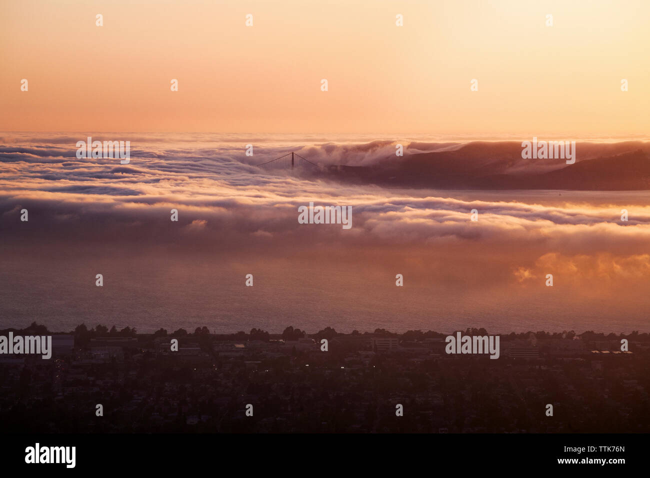 Digital composite image of waves and city during sunset Stock Photo
