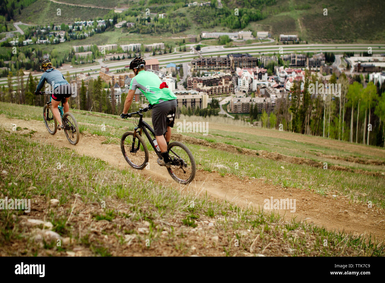 Woman cycling field rear view hi-res stock photography and images - Alamy