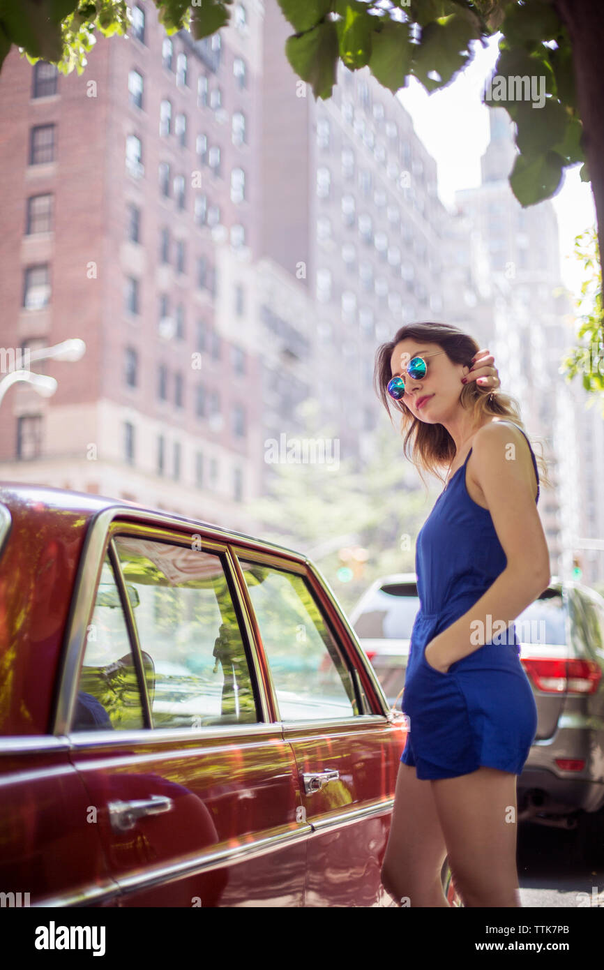 Fashionable woman standing near vintage car Stock Photo