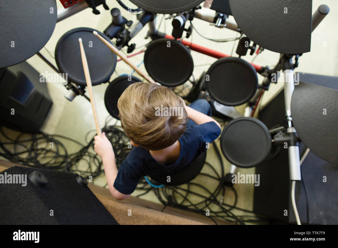 Overhead view of boy playing drum kit at Grace Baptist Church Stock Photo