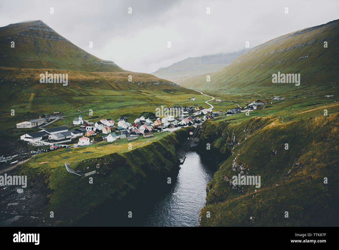 Scenic view of Faroe islands against cloudy sky Stock Photo