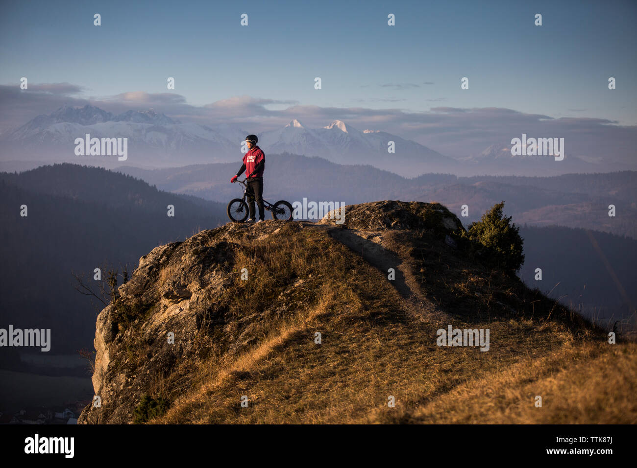 young men with bmx is standing on the rock Stock Photo