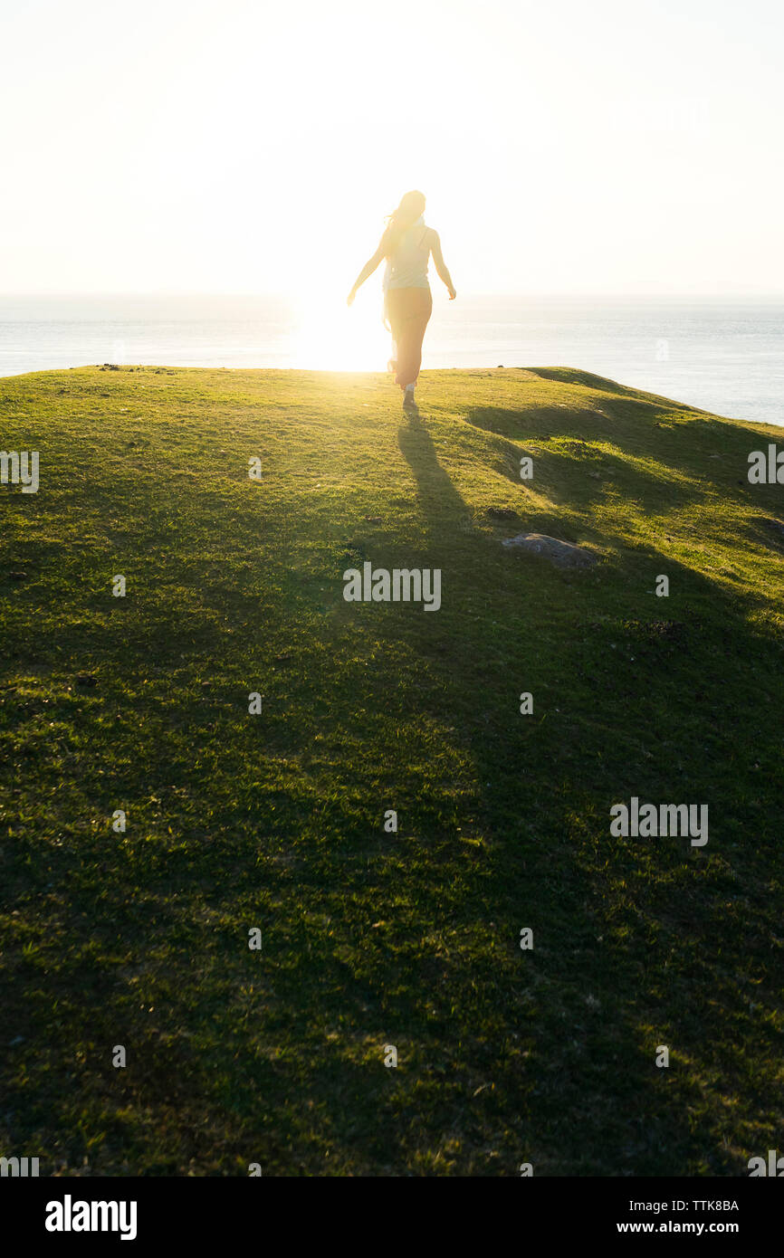 Back view woman walking sea hi-res stock photography and images - Alamy