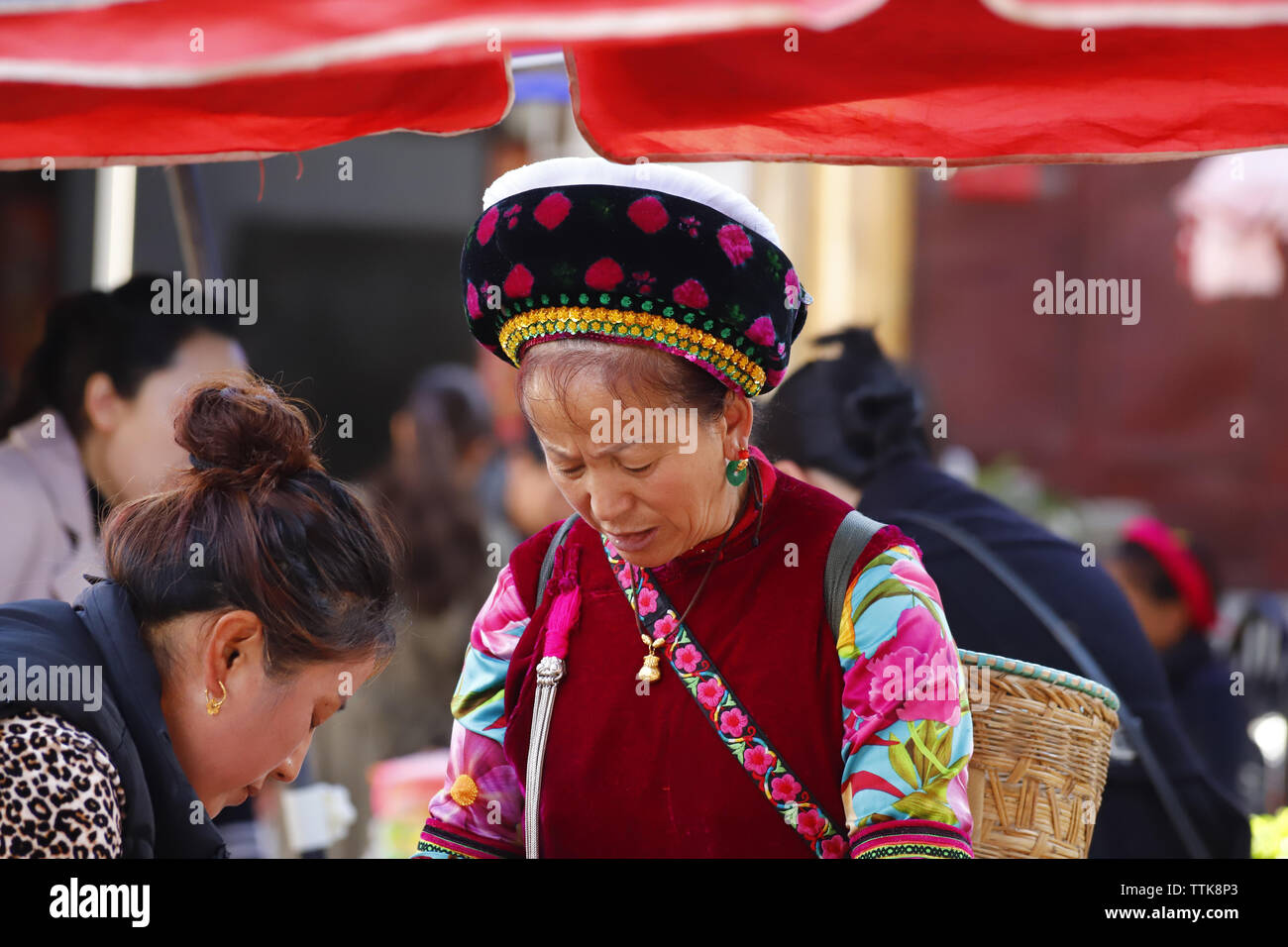 People of an ethnic minority of Yunnan with their traditional clothes in the market of Zhoucheng village, Dali, Yunnan, China Stock Photo