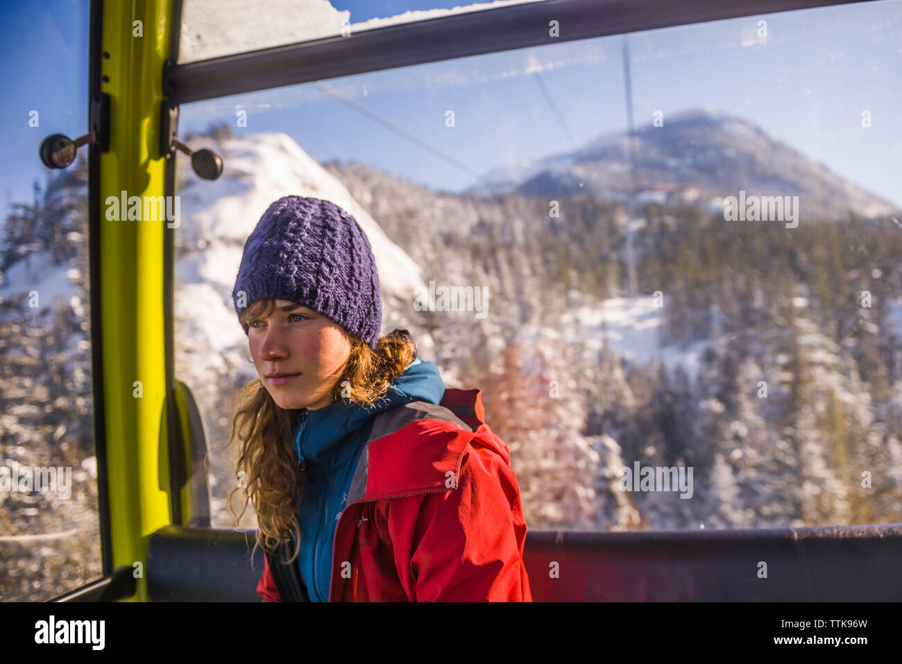 Woman looking away from Sea to Sky gondola in Squamish Stock Photo