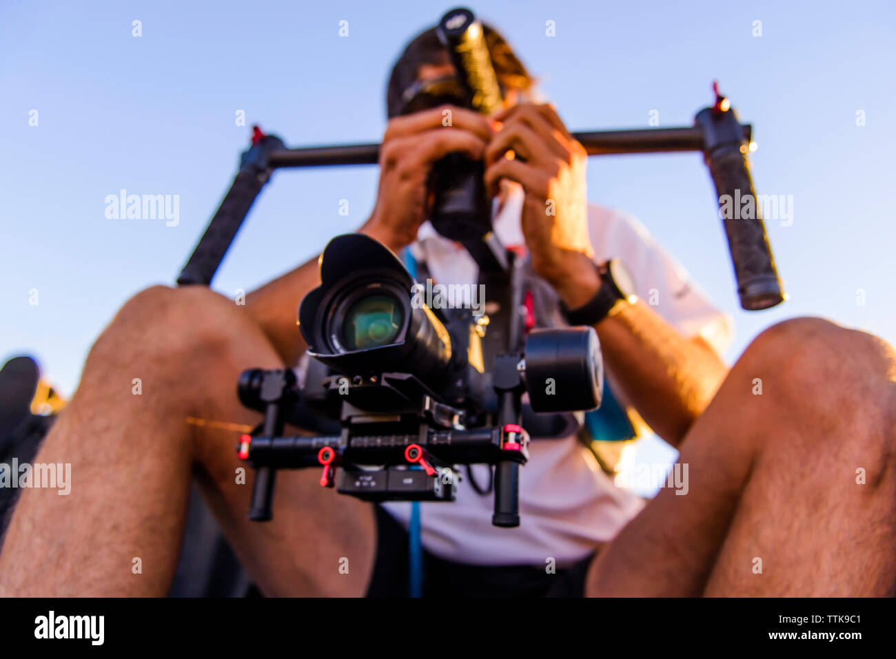 Videographer shooting using a Gimbal stabilizer with DSLR Stock Photo