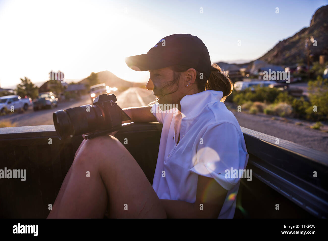 Young Smiling Woman Capturing landscapes using DSLR camera from car Stock Photo