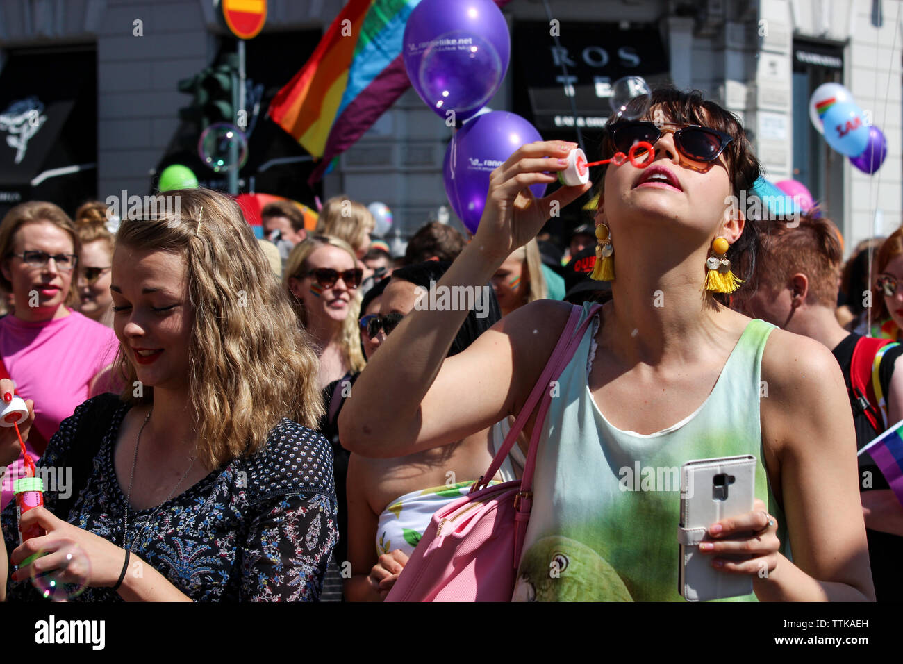 Woman blowing soap bubbles at Helsinki Pride Parade 2016 in Helsinki, Finland Stock Photo