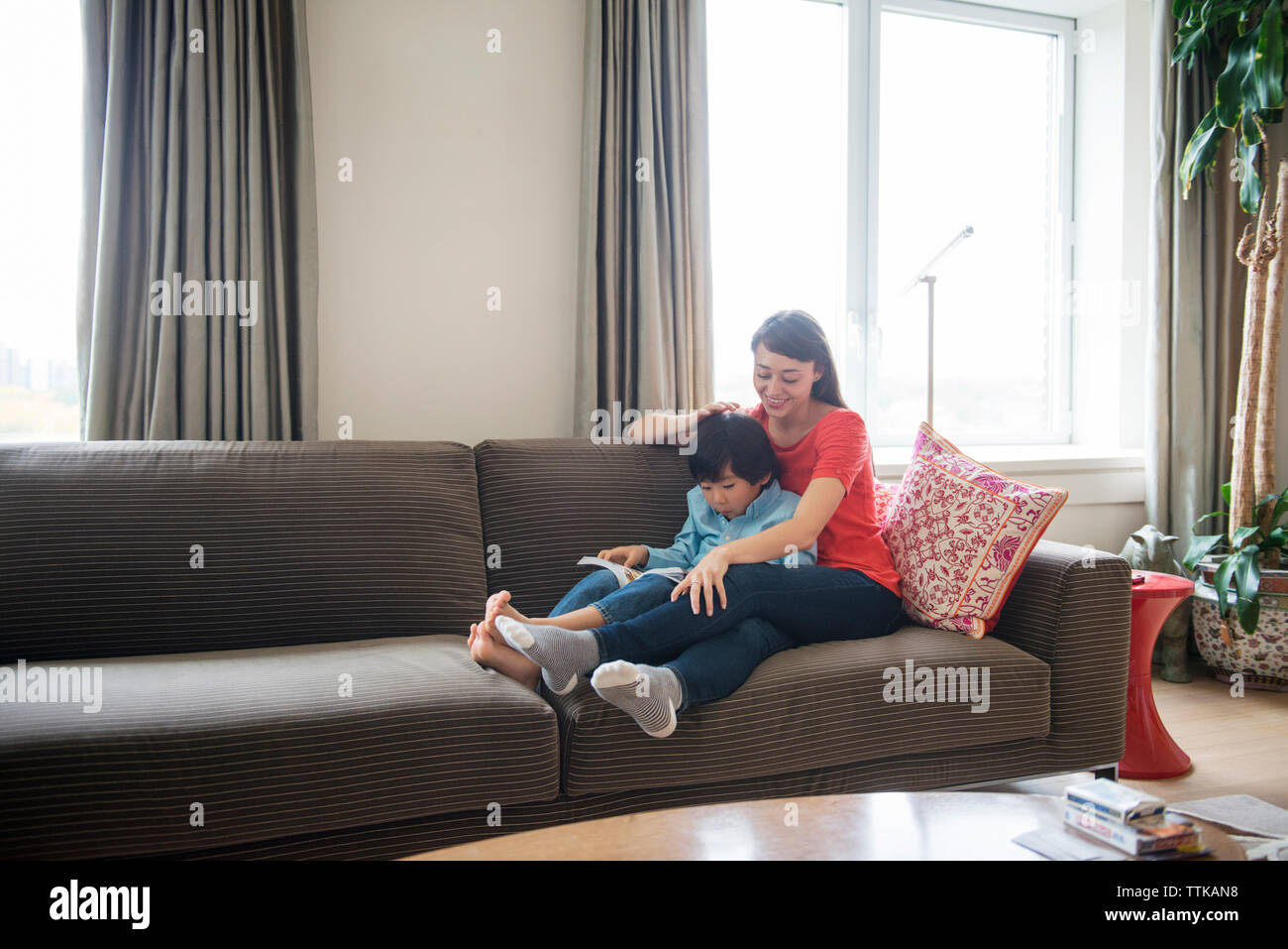 Mother son sitting on sofa hi-res stock photography and images - Alamy