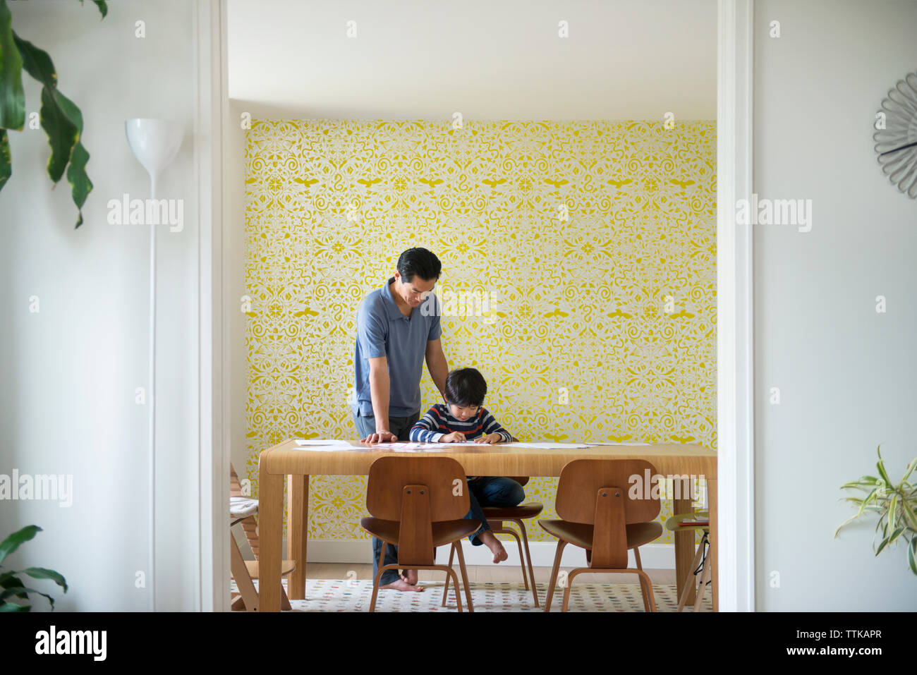 Father helping son with homework at home Stock Photo - Alamy