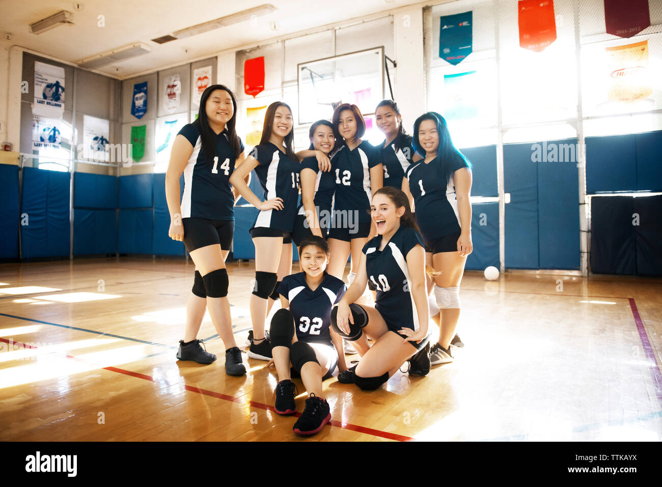 Portrait of happy female volleyball team at court Stock Photo