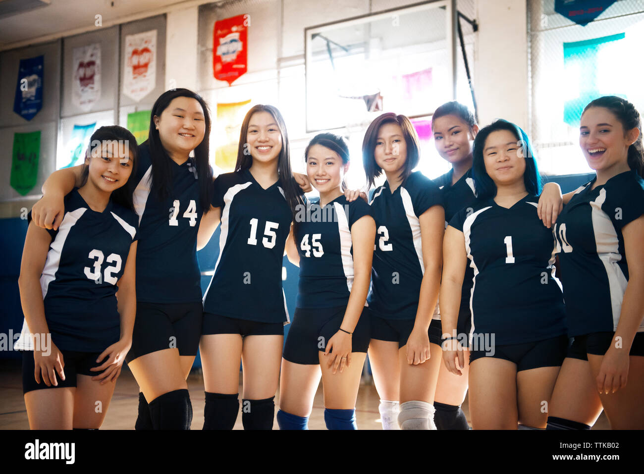 Portrait of teenage girls volleyball team at court Stock Photo