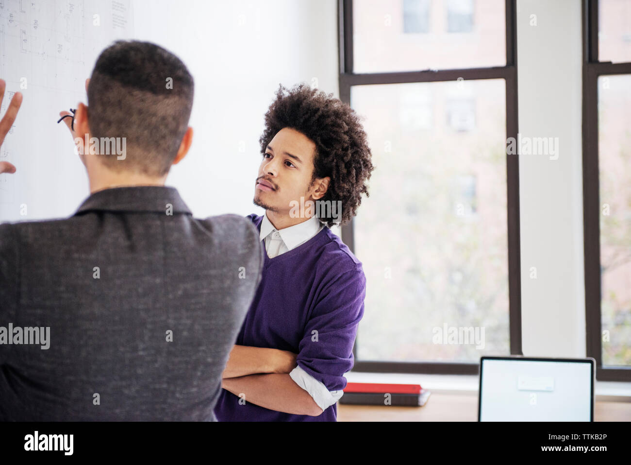 businessmen discussing over chart in creative office Stock Photo