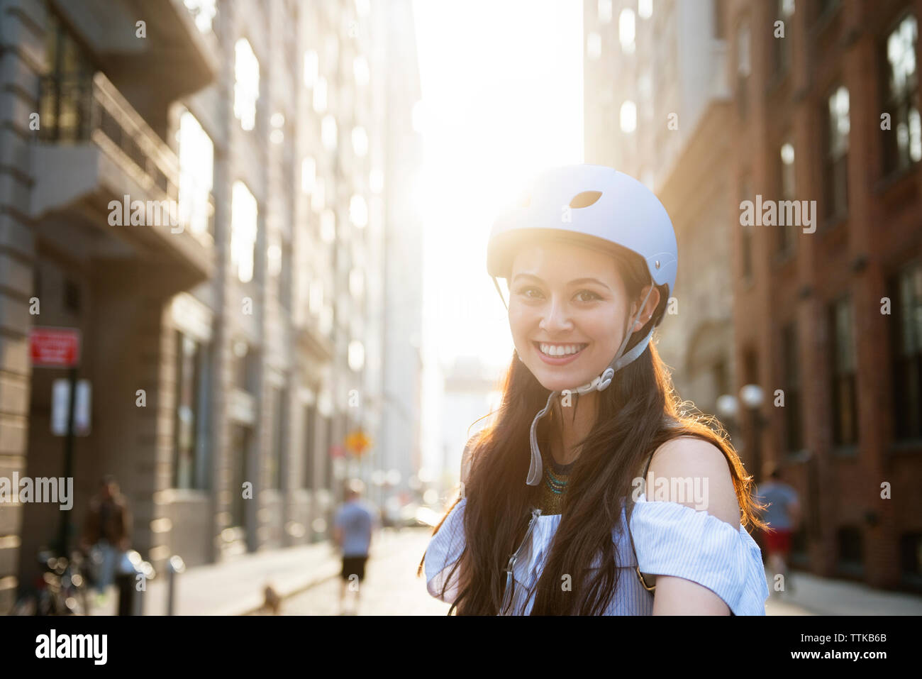 Smiling young woman wearing helmet hi-res stock photography and images ...