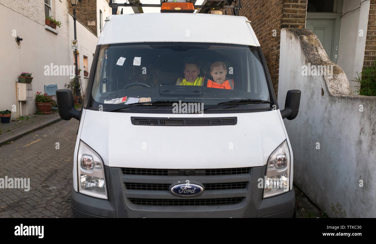 A builder's van with cardboard cut-outs of princes William and Harry set above the front seat. Stock Photo