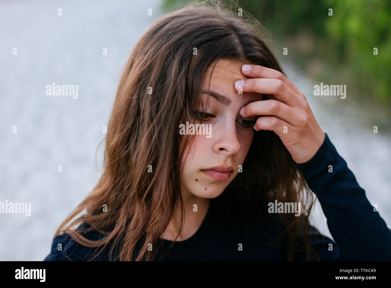 thoughtful girl put her hand to her forehead Stock Photo