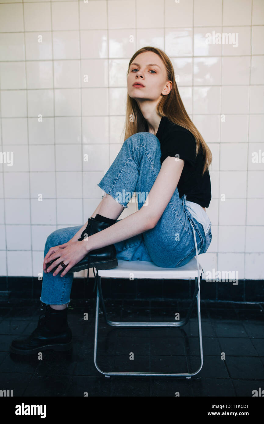 Blonde woman sitting on a chair hi-res stock photography and images - Alamy