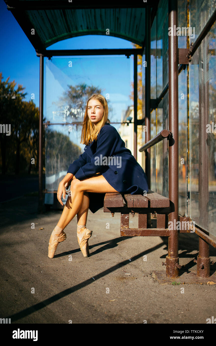 Woman Ballerina In The City Sits On A Bench At The Bus Stop Stock