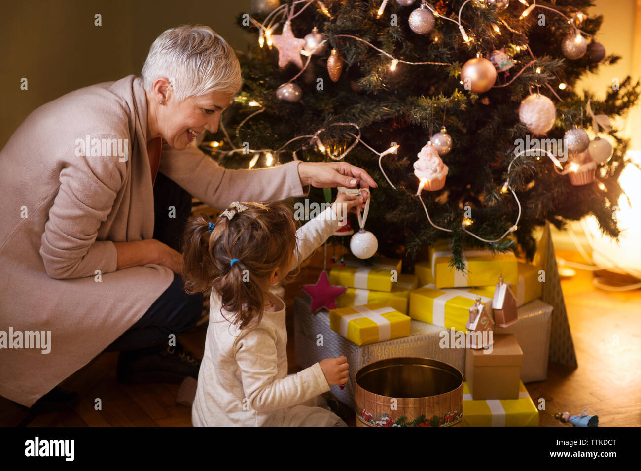 Excited Grandmother Receiving Christmas Gift From Granddaughter At Home  Stock Photo - Alamy