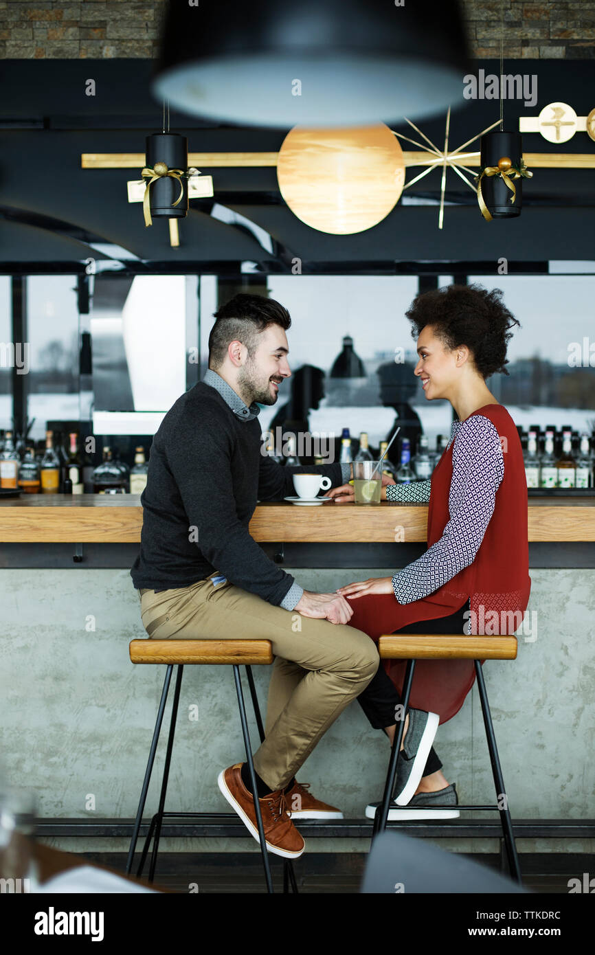 business couple sitting face to face at cafe counter Stock Photo