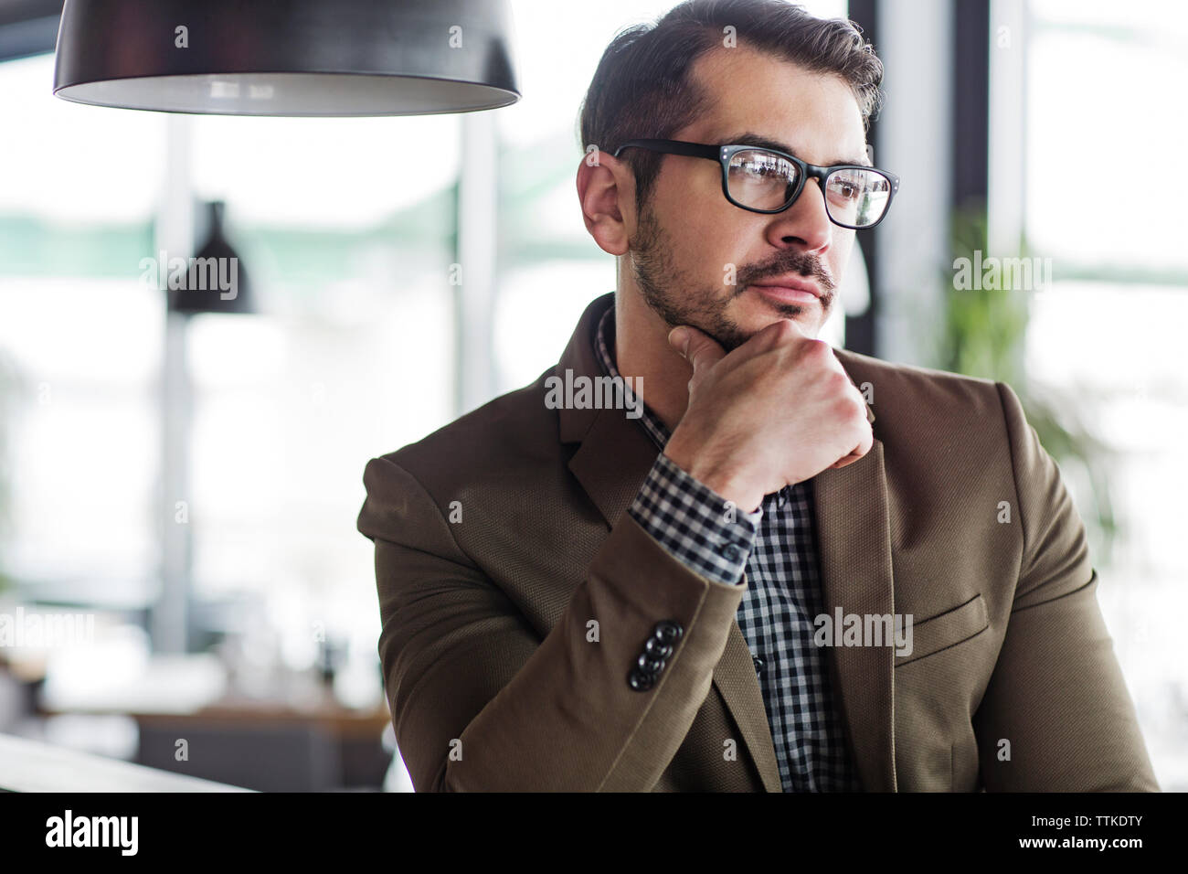 Thoughtful businessman looking away in restaurant Stock Photo