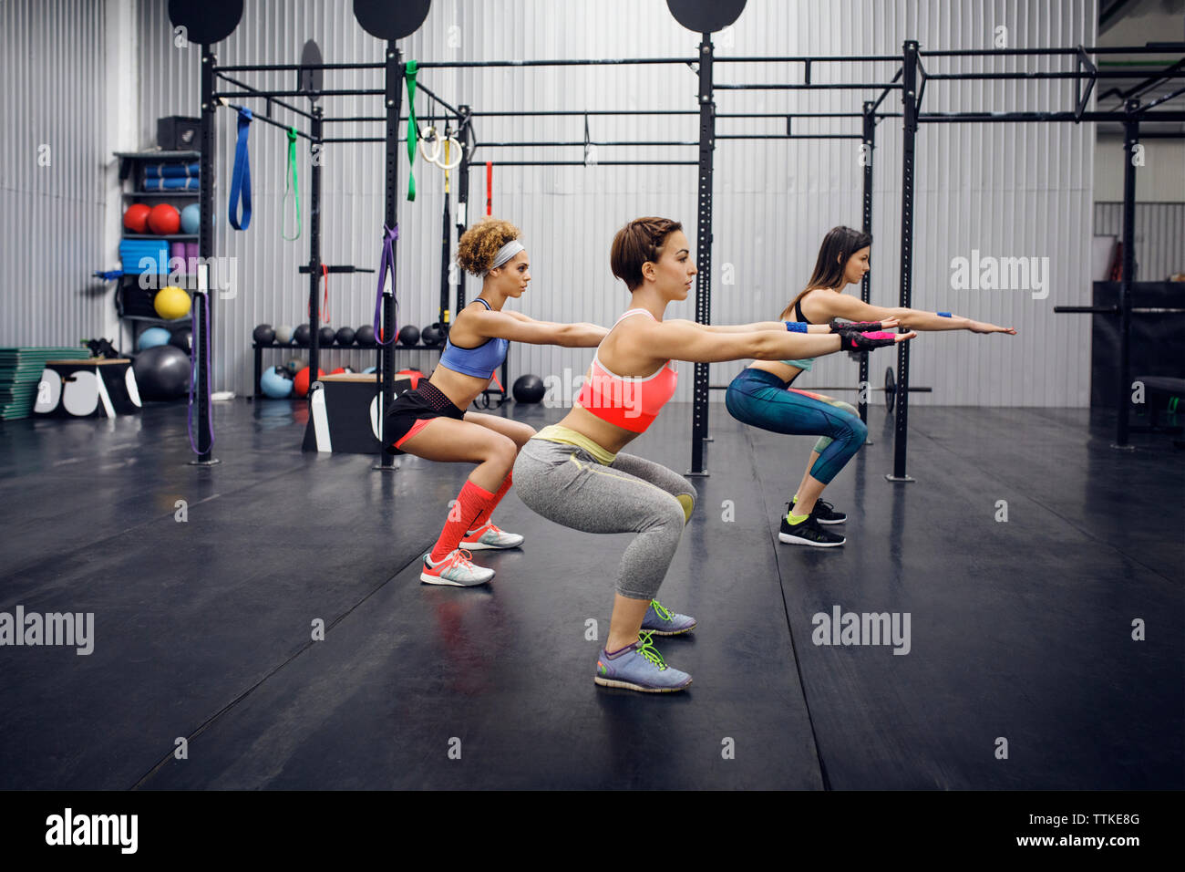 Side view of confident female athletes exercising in health club Stock Photo