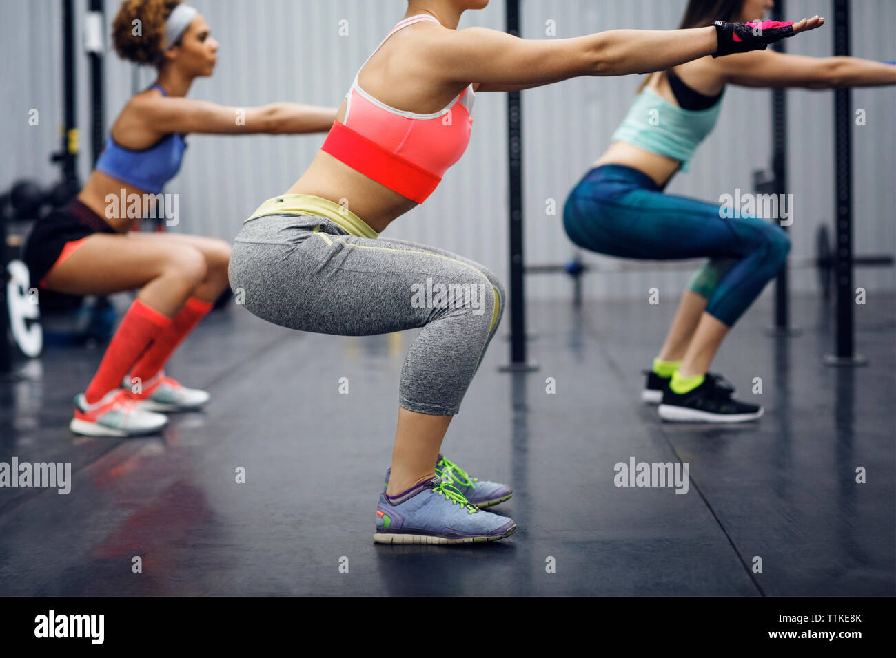 Side view of athletes exercising in gym Stock Photo