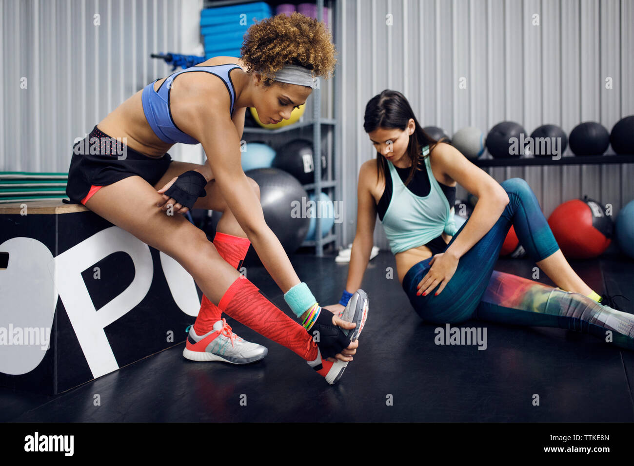 Female athletes exercising in health club Stock Photo