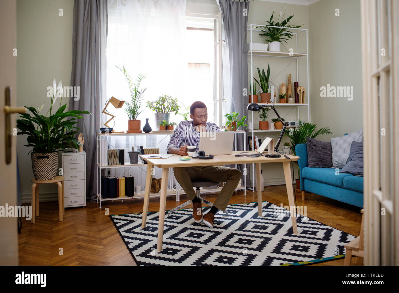 Man working on laptop at home office Stock Photo