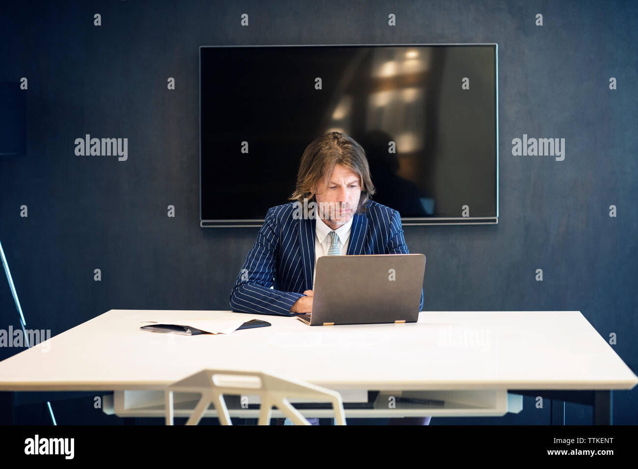 Mature businessman using laptop computer in office Stock Photo - Alamy