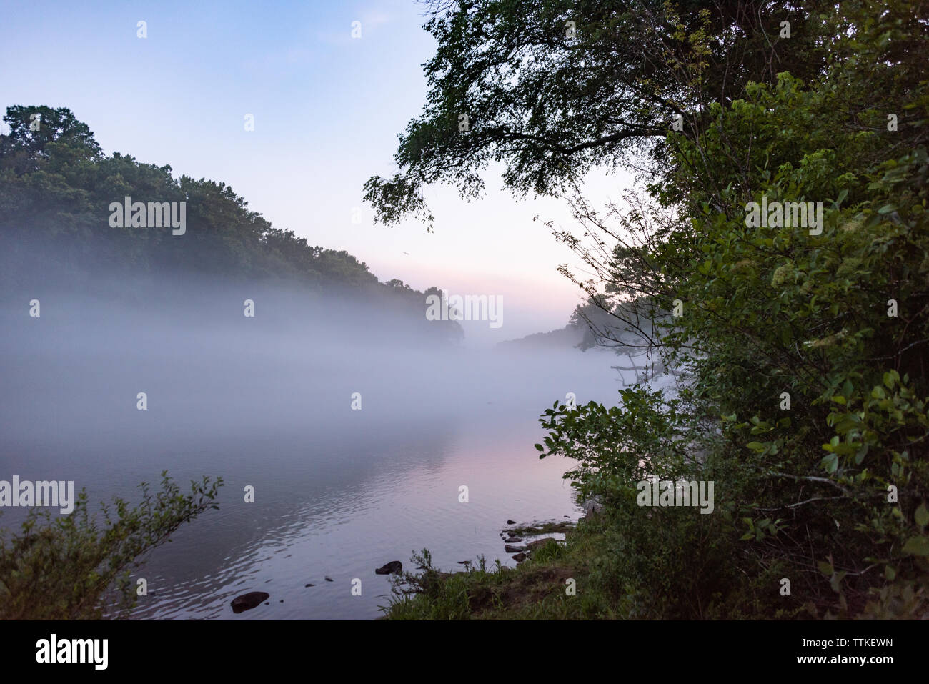 A layer mist floats above the Chattahoochee River at dusk near Lake Lanier and just Northeast of Atlanta, Georgia. (USA) Stock Photo