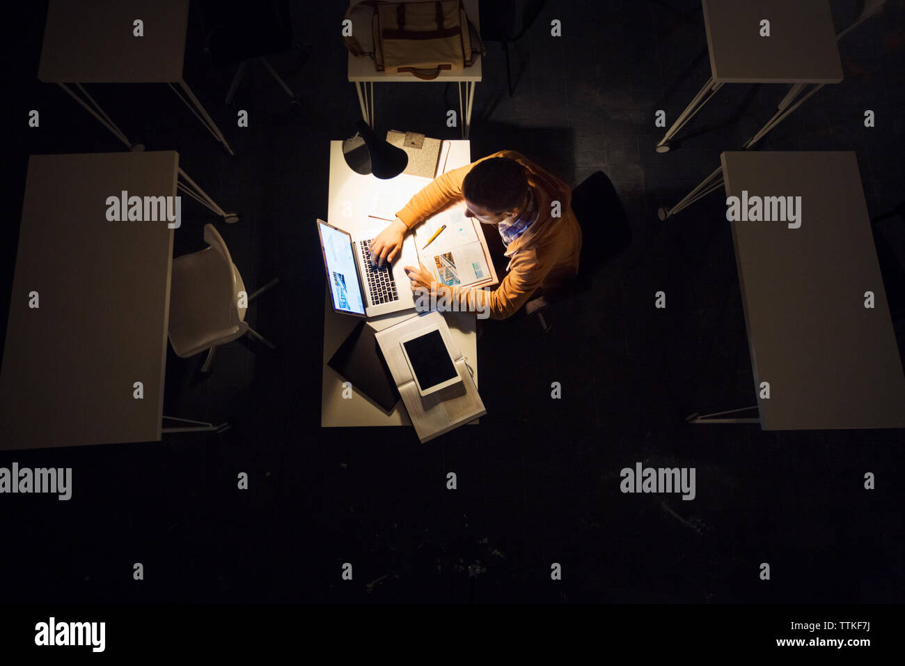 High angle view of man studying on laptop computer in library Stock Photo