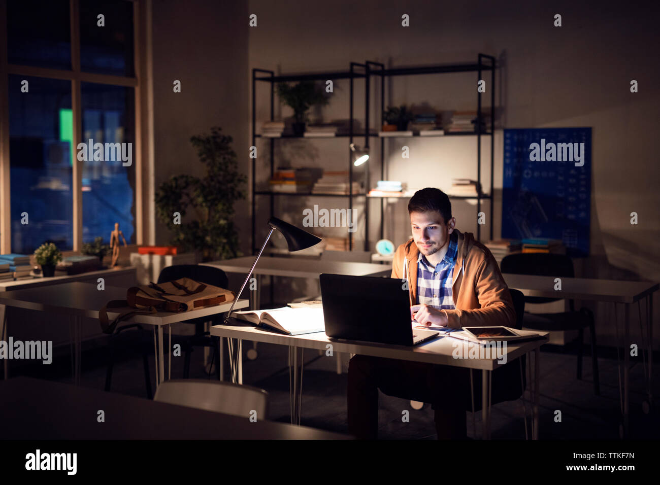studying under table lamp
