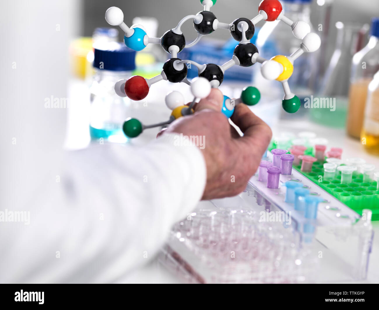 Cropped hand of scientist holding molecular structure in laboratory Stock Photo