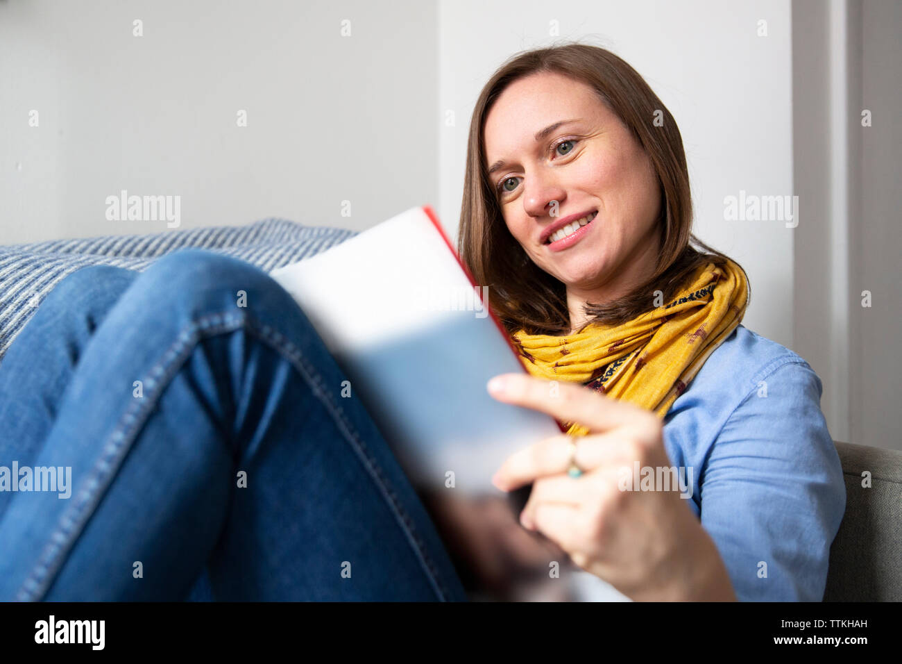 Woman reading smiling home hi-res stock photography and images - Alamy