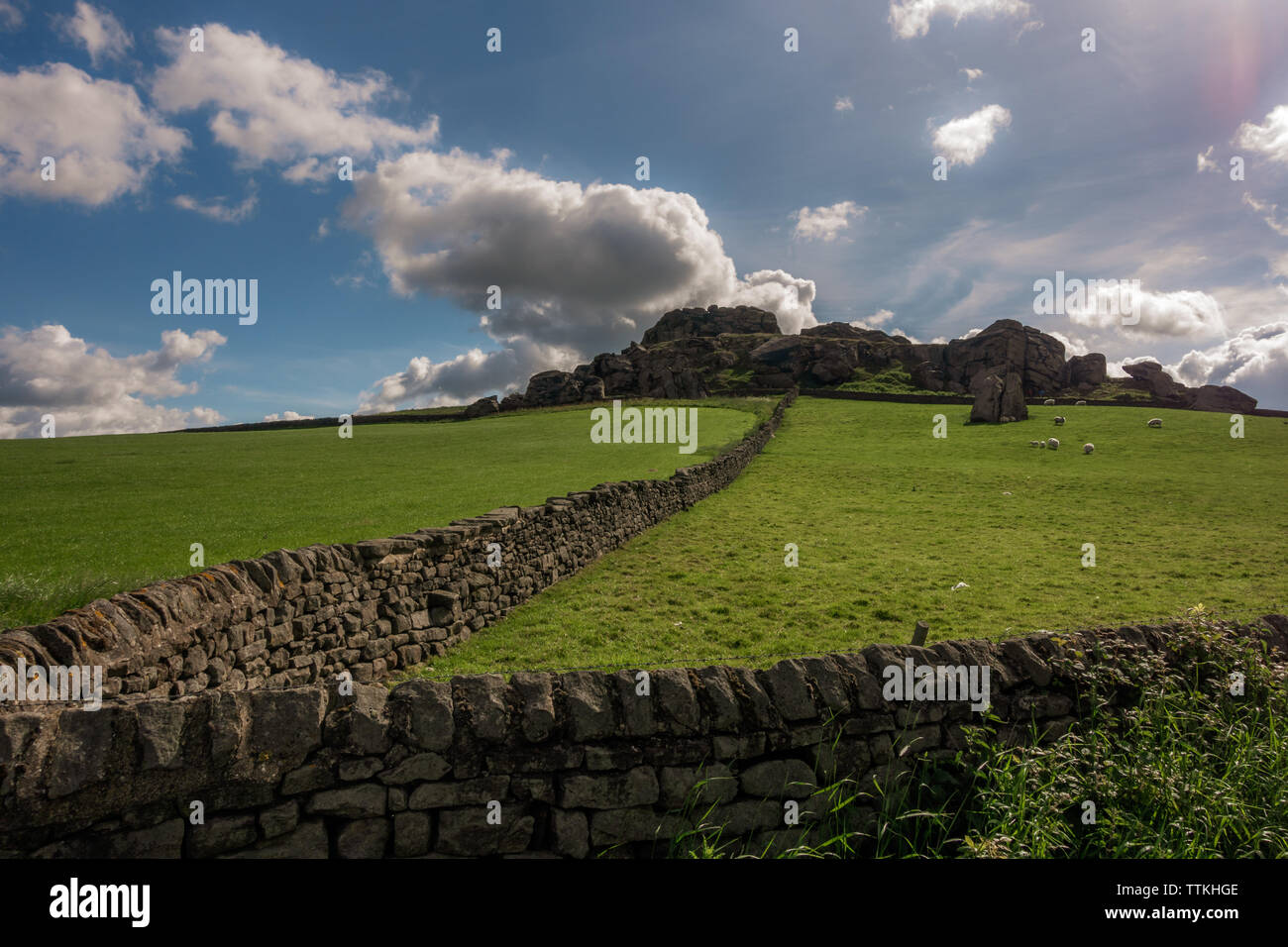UK landscape: View of Almscliffe Crag from the behind a stone wall, North Yorkshire Stock Photo