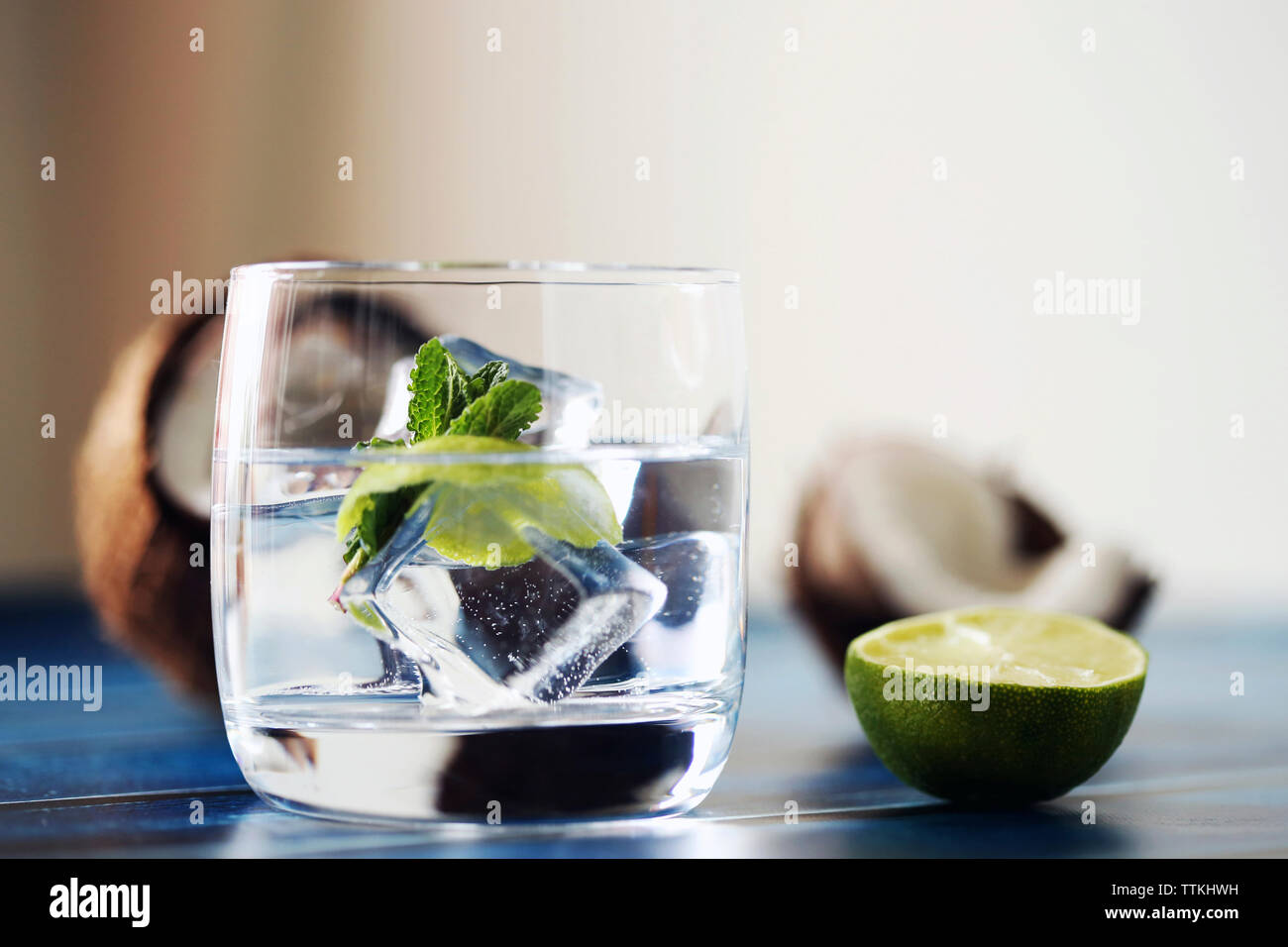 Close-up of ice cubes in drink with fruits on table Stock Photo