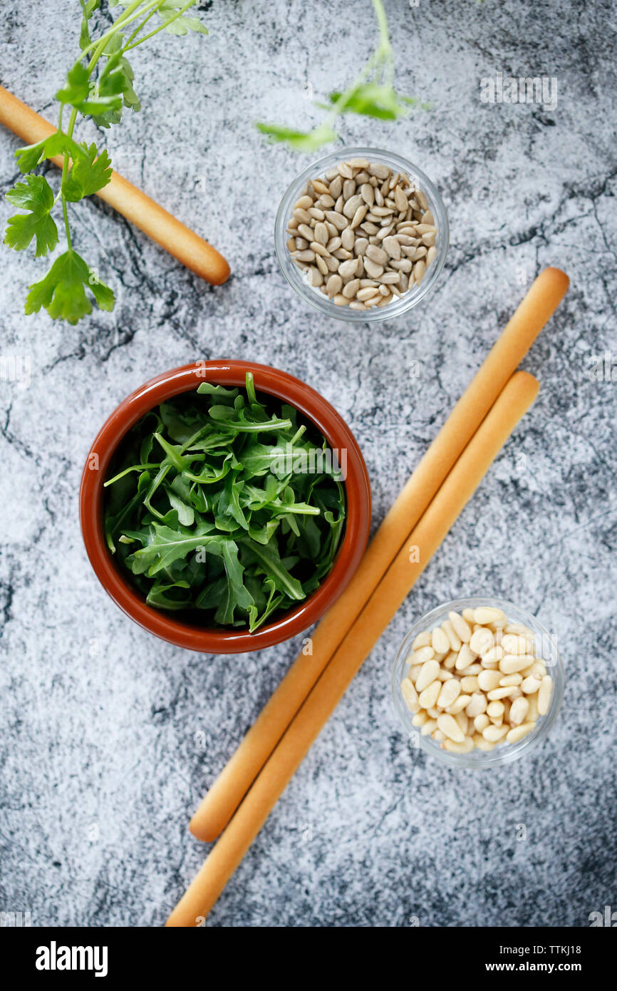 Overhead view of breadsticks with parsley and seeds on table Stock Photo