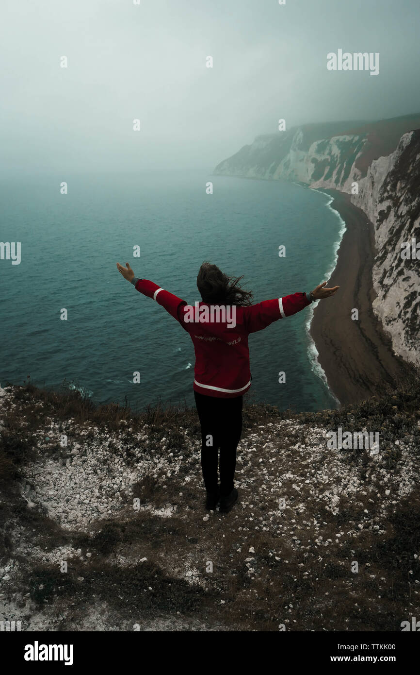 Young girl on the edge of a cliff Stock Photo - Alamy