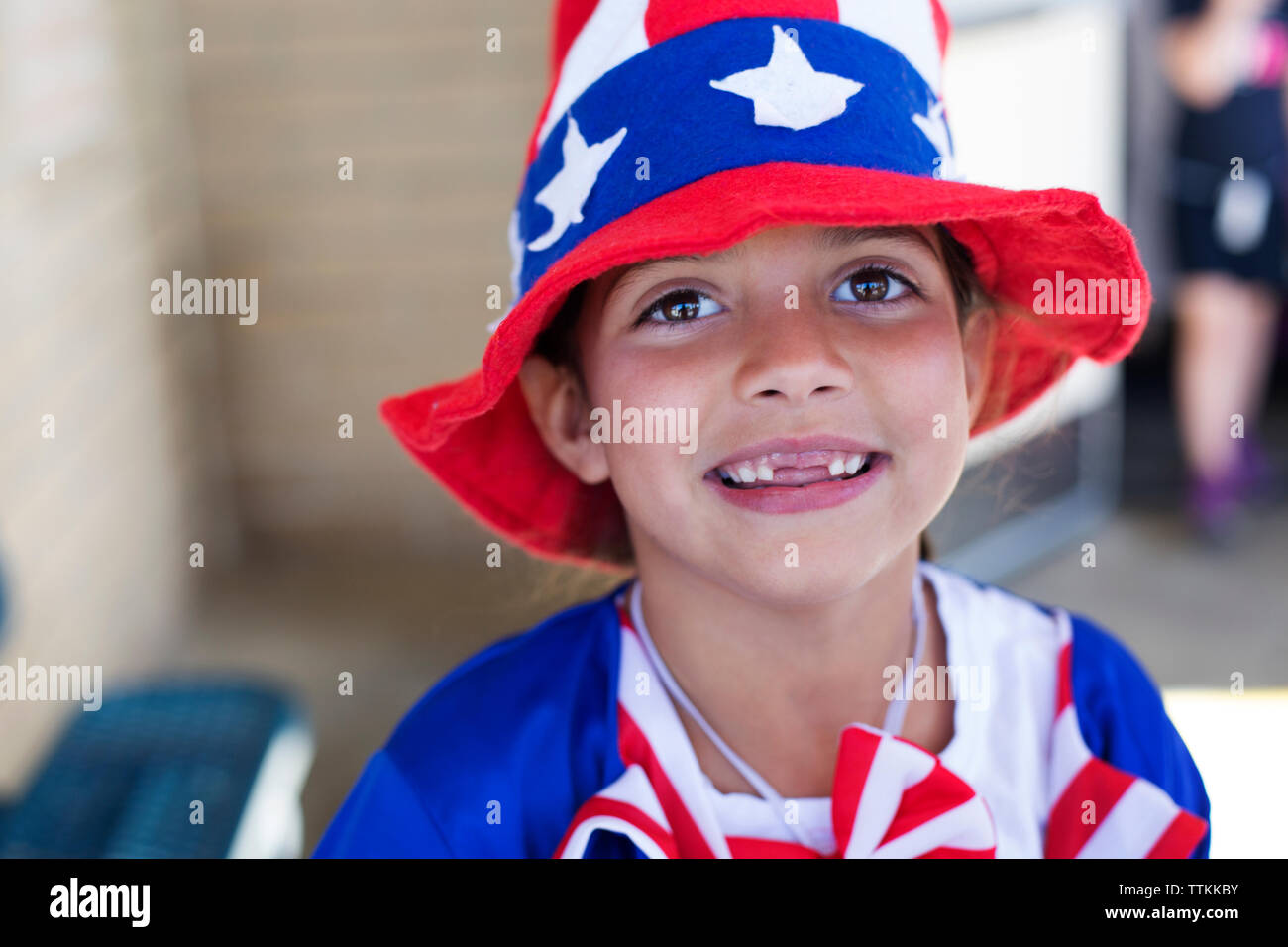Portrait of cute girl wearing American Flag hat outdoors Stock Photo